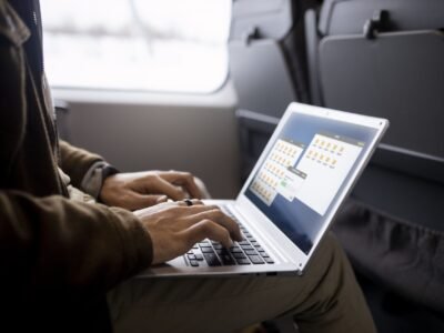 man-working-his-laptop-while-traveling-by-train